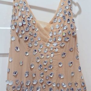 Absolutely stunning statement piece. Embellished jewels adorn this dress.